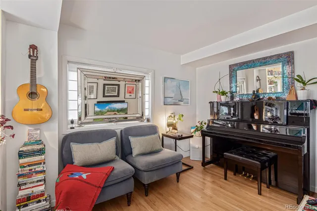 a living room with furniture and a piano