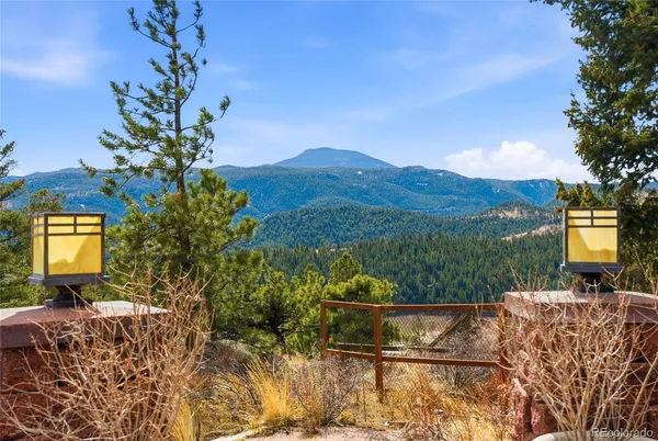 a view of balcony with furniture and a garden