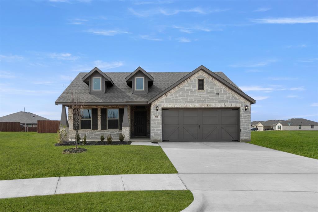 301 Comanche Drive Cleburne, TX 76033 - Photo 1 of 1 a front view of a house with a yard and garage