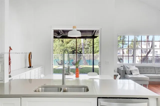 a kitchen with a sink and large window