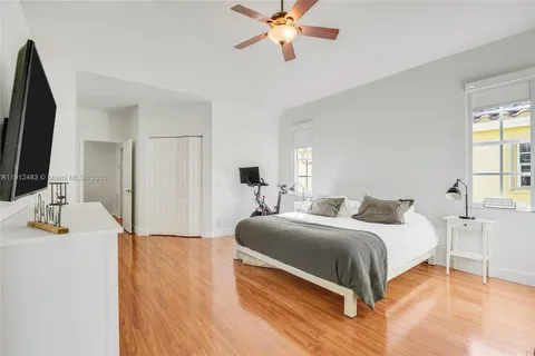 a bedroom with a bed window and a flat screen tv