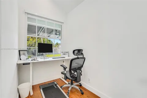 a view of workspace with wooden floor windows