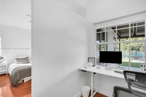a view of workspace with wooden floor windows
