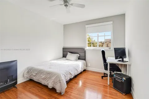 a bedroom with a bed and a tv on table