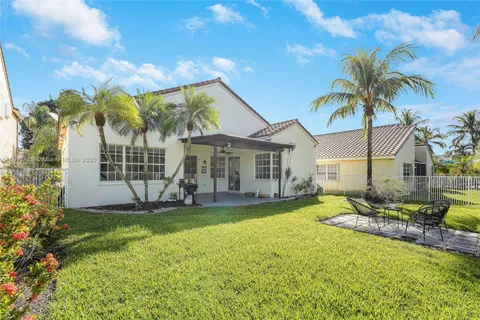 a view of a house with a swimming pool and sitting area