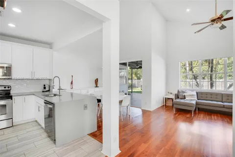 a view of kitchen with sink and wooden floor