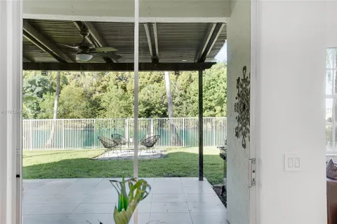 a backyard of a house with a garden and outdoor seating