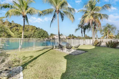 a view of a lake with a palm trees