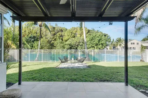 a backyard of a house with a fountain table and chairs