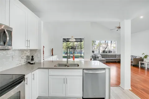 a kitchen with sink cabinets and window