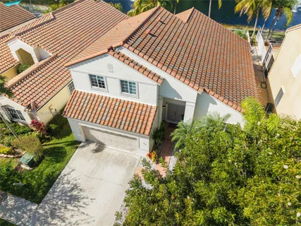 a view of a house with a yard and sitting area