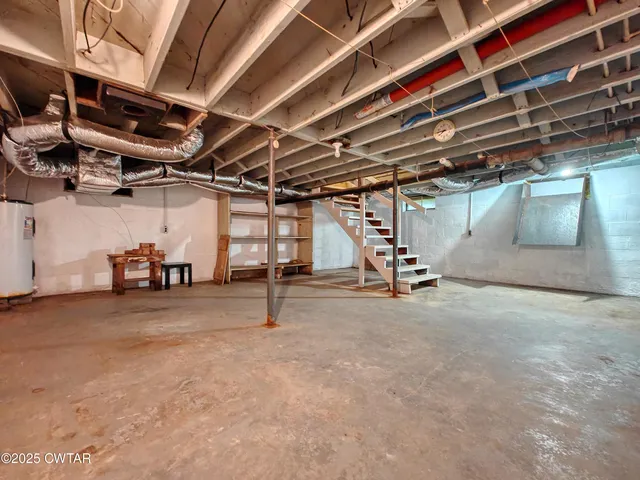 a view of empty room with wooden ceiling