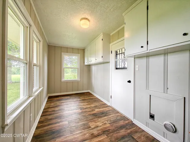 a view of an entryway with wooden floor