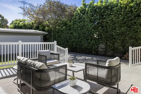 a view of a chair and table in the balcony
