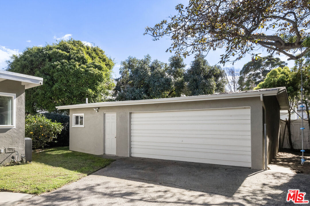 716 West Oak Avenue El Segundo, CA 90245 - Photo 34 of 35 a view of a white house with a large tree and a yard