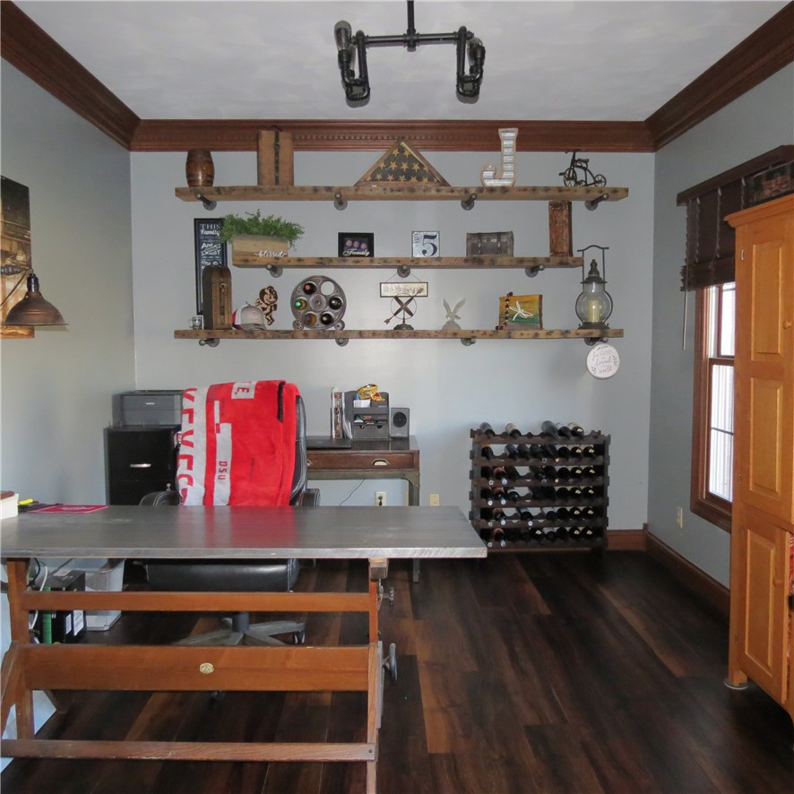 10160 Lochard Road Sidney, OH 45365 - Photo 17 of 41 This versatile space features rich wood flooring, crown molding, and built-in shelving, perfect for any use.