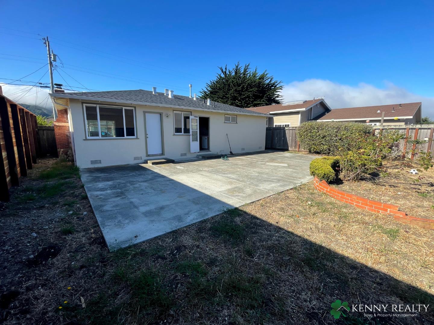 1059 Anza Drive Pacifica, CA 94044 - Photo 18 of 18 a front view of a house with a yard and garage