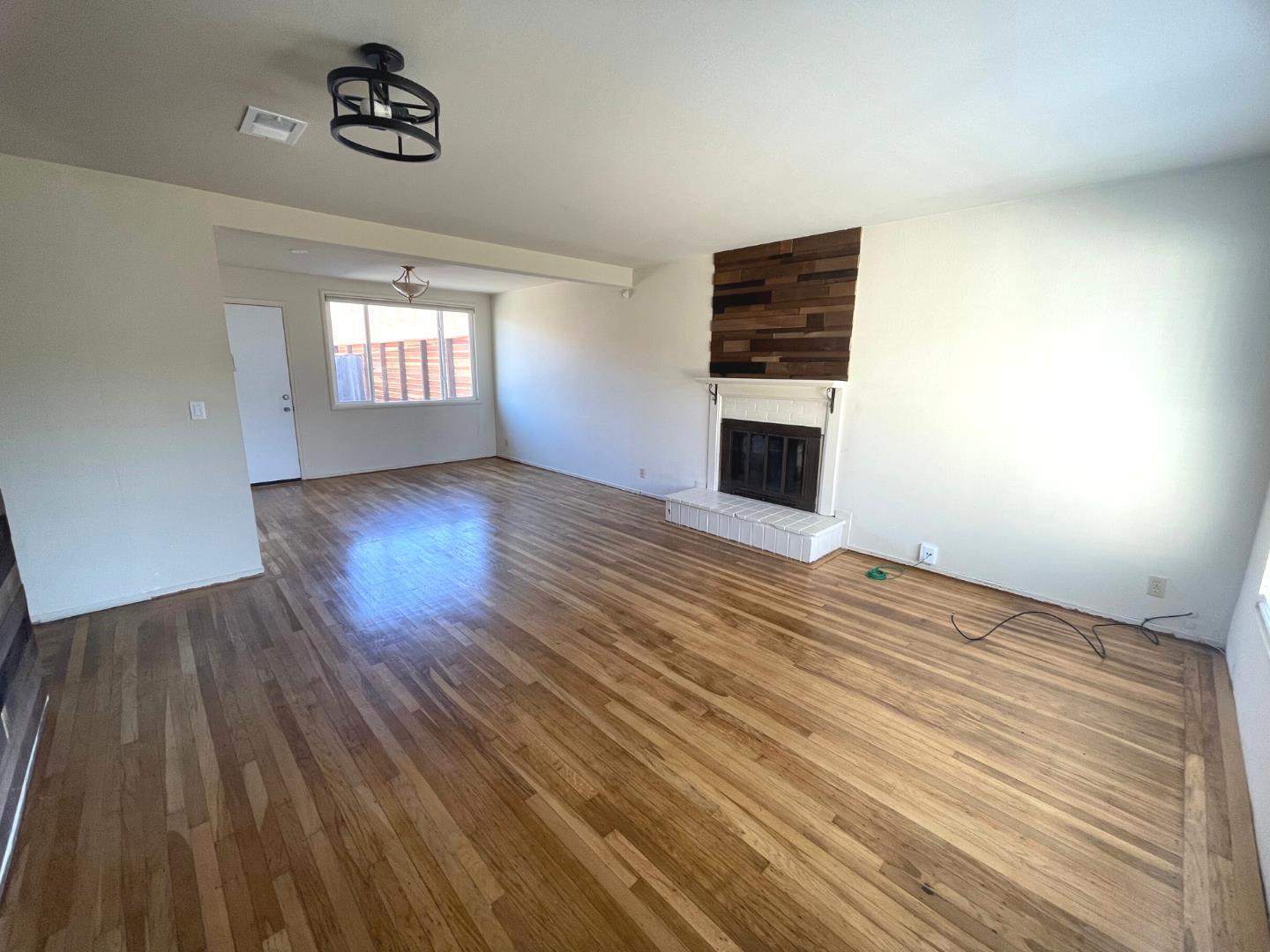 1059 Anza Drive Pacifica, CA 94044 - Photo 2 of 18 wooden floor in an empty room with a window
