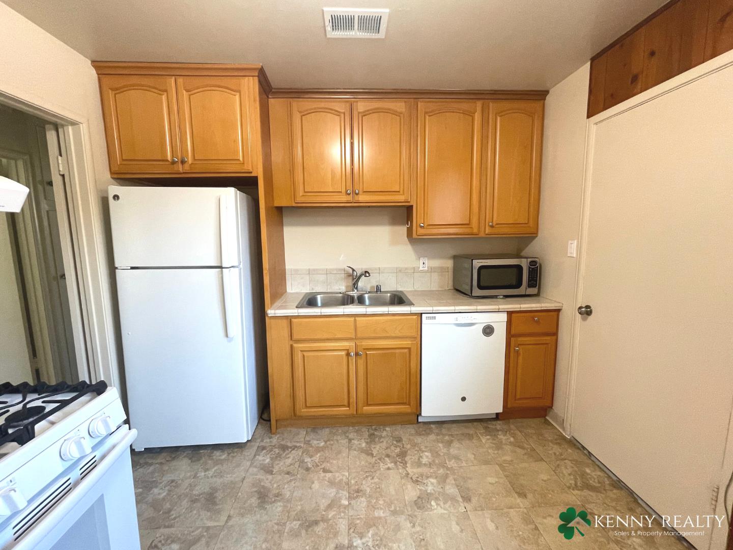 1059 Anza Drive Pacifica, CA 94044 - Photo 6 of 18 a kitchen with a refrigerator sink stove and cabinets