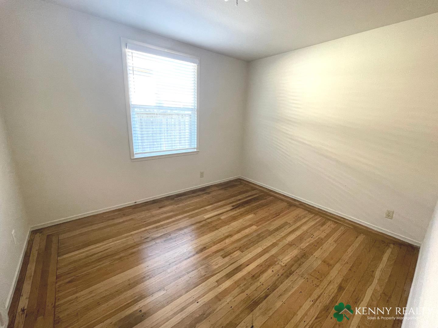 1059 Anza Drive Pacifica, CA 94044 - Photo 10 of 18 a view of empty room with wooden floor and fan