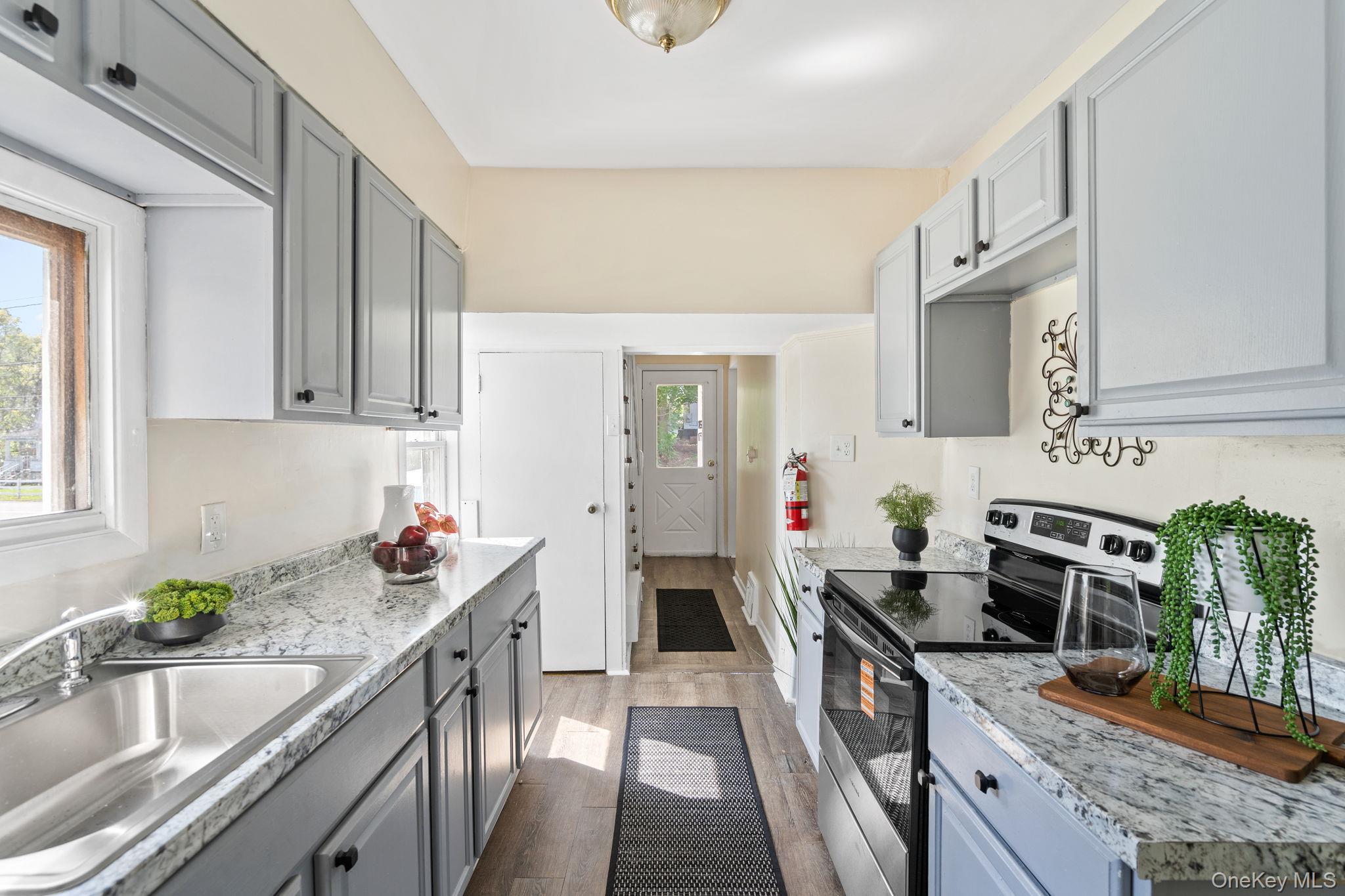 8 Coldenham Road Walden, NY 12586 - Photo 14 of 50 Kitchen featuring stainless steel electric range oven, gray cabinets, dark wood-type flooring, and light stone countertops