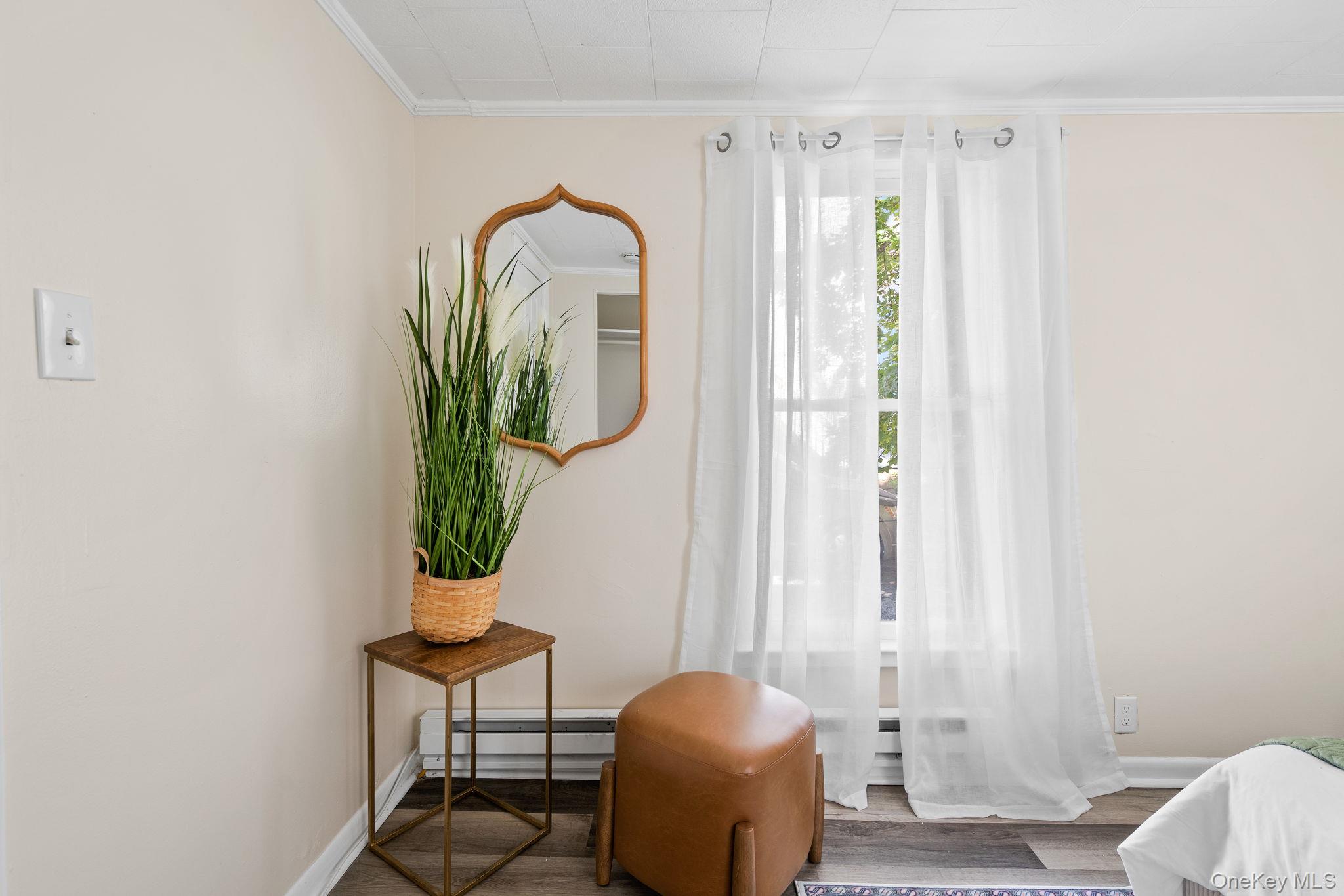 8 Coldenham Road Walden, NY 12586 - Photo 22 of 50 Sitting room with ornamental molding, a baseboard heating unit, and wood finished floors