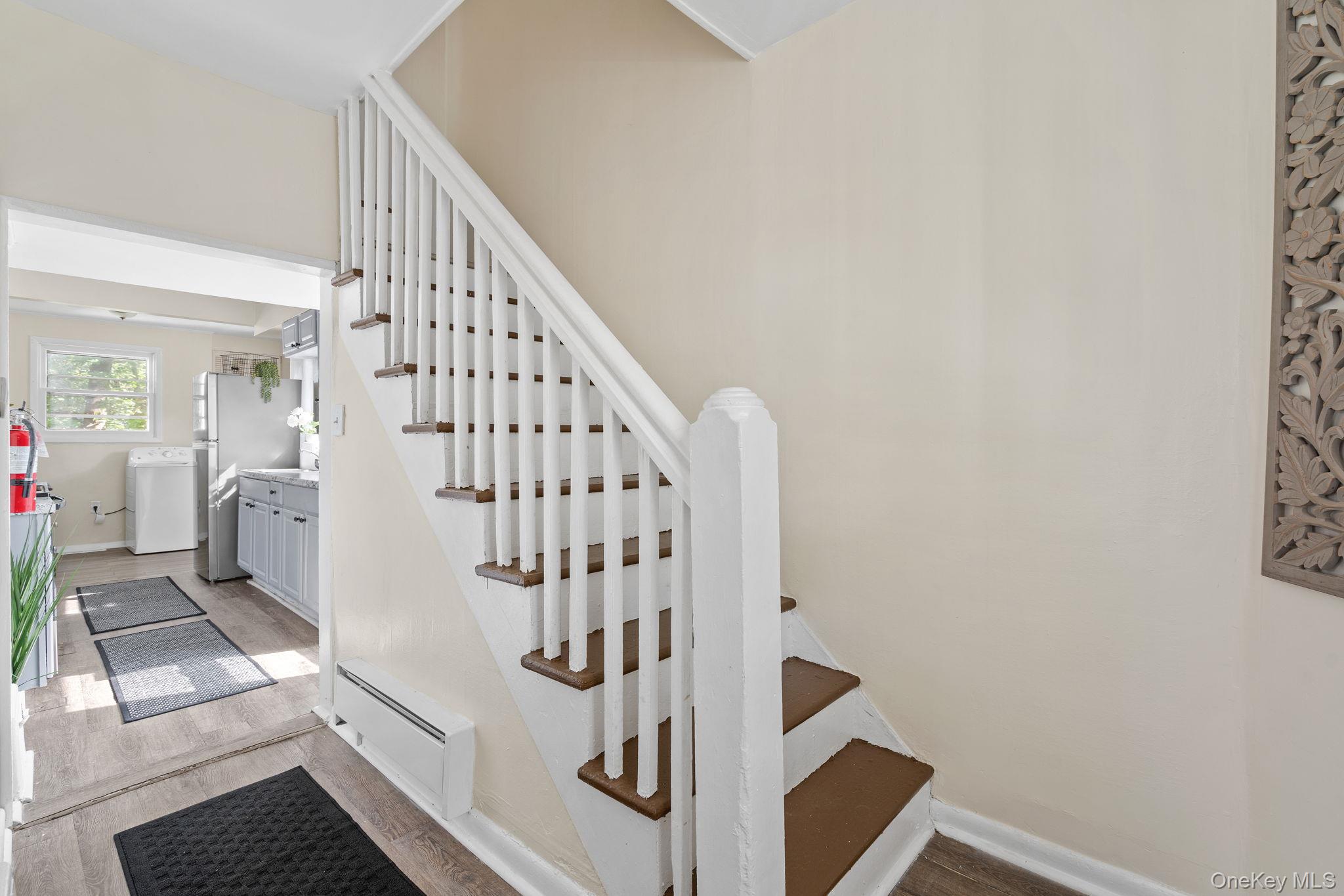 8 Coldenham Road Walden, NY 12586 - Photo 23 of 50 Stairway with a baseboard radiator, wood finished floors, and washer / dryer