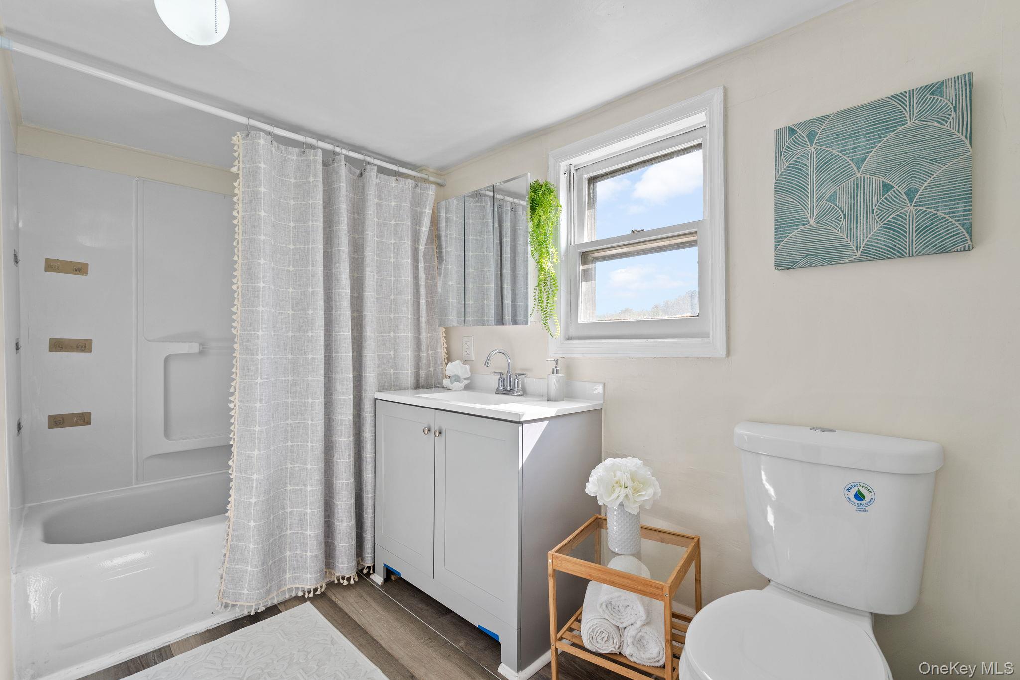 8 Coldenham Road Walden, NY 12586 - Photo 32 of 50 Full bath featuring vanity, shower / bath combination with curtain, and wood finished floors