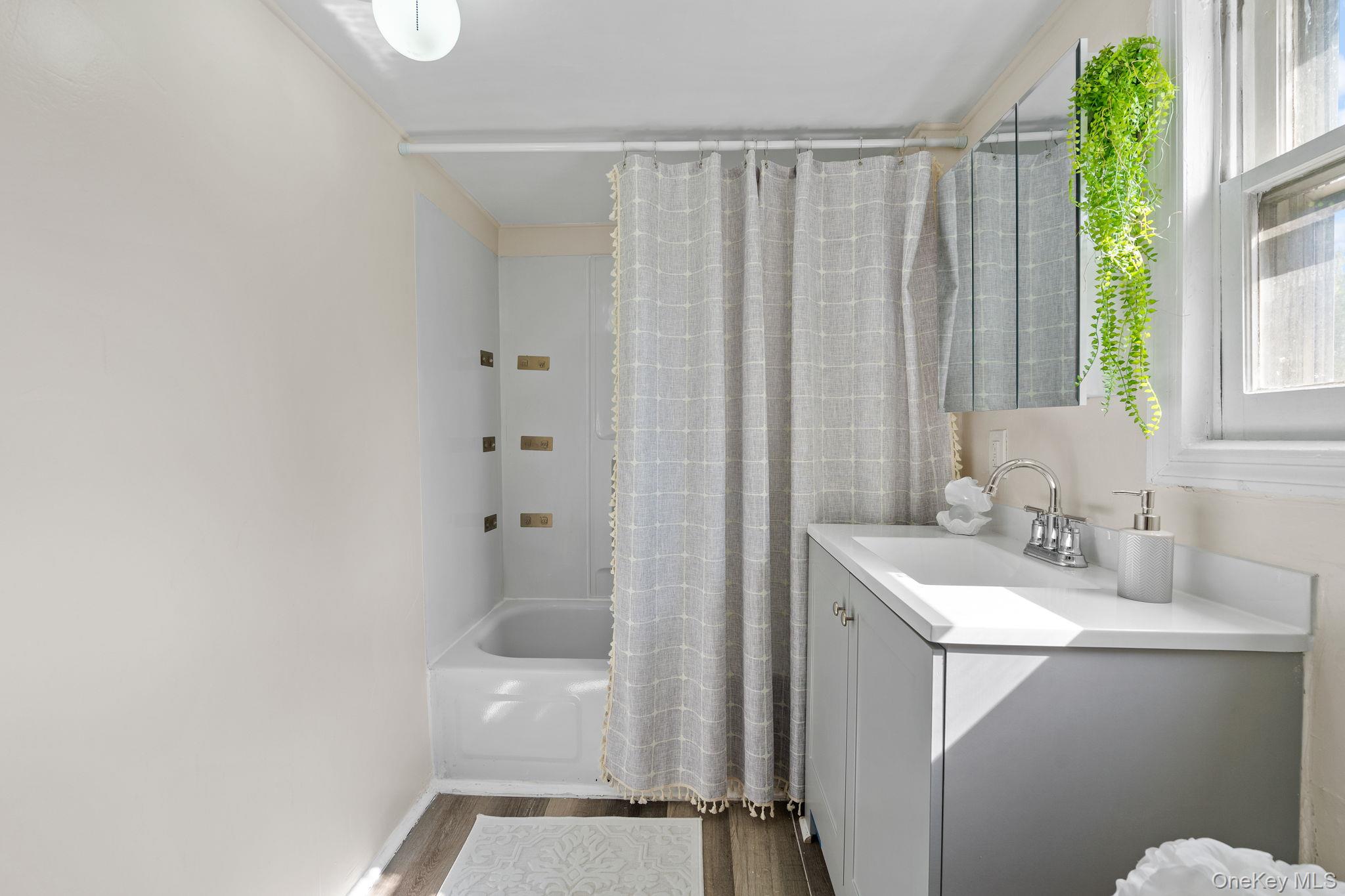 8 Coldenham Road Walden, NY 12586 - Photo 33 of 50 Full bathroom featuring vanity, shower / bath combination with curtain, and dark wood-style flooring