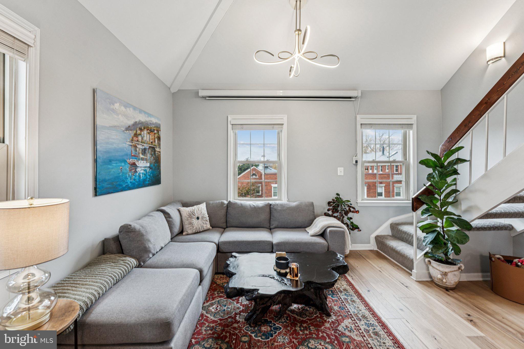 509 Bashford Lane, Unit 6 Alexandria, VA 22314 - Photo 10 of 20 a living room with furniture and a chandelier
