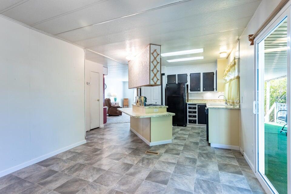 11037 Erickson Way, Unit 71 Redding, CA 96003 - Photo 6 of 13 a view of a kitchen with refrigerator and window