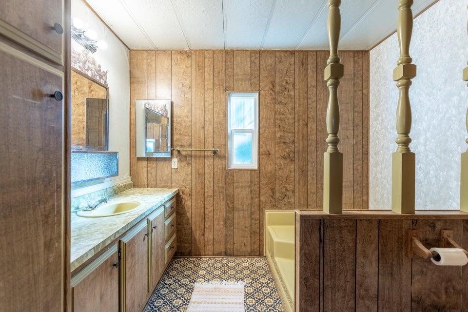 11037 Erickson Way, Unit 71 Redding, CA 96003 - Photo 10 of 13 a bathroom with a granite countertop sink and a mirror