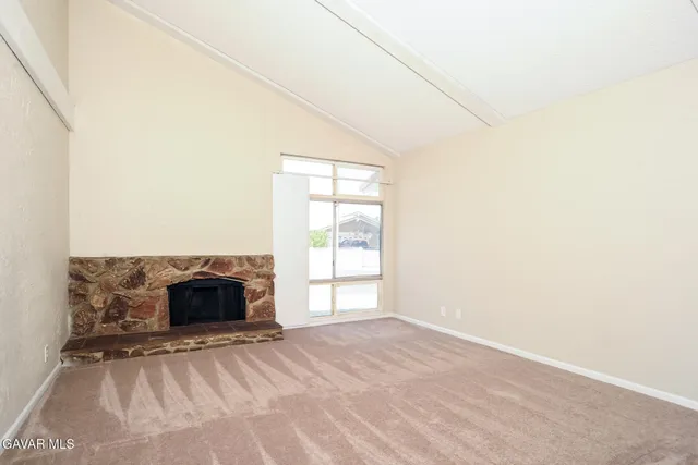 a view of empty room with a fireplace