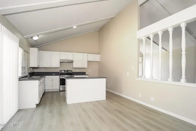 a kitchen with stainless steel appliances a refrigerator and a stove top oven