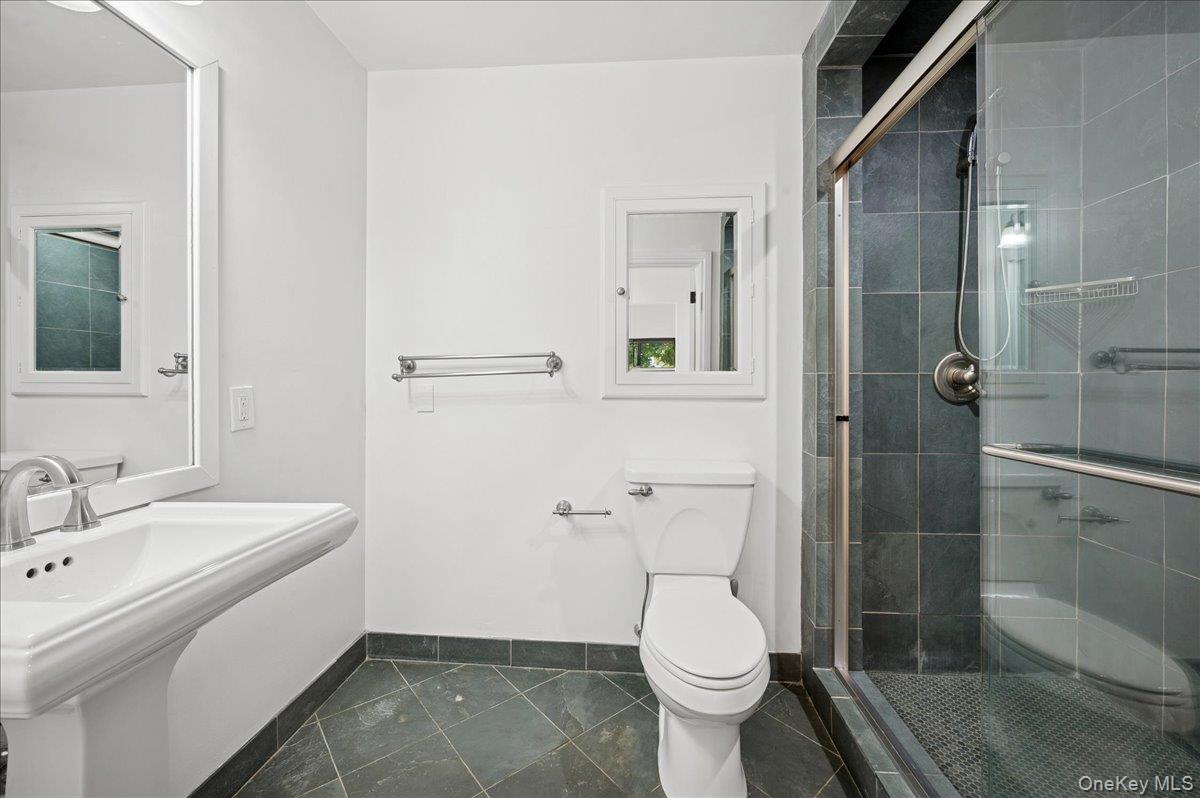 70 Waters Edge, Unit 70 Rye, NY 10580 - Photo 28 of 44 Full bathroom featuring a large shower stall and dark tile patterned flooring. Next to dressing area & walk-in closet