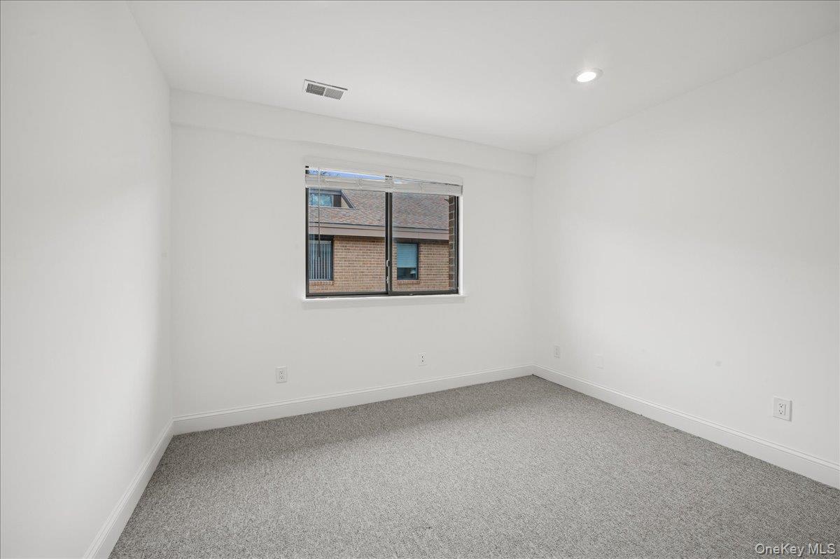 70 Waters Edge, Unit 70 Rye, NY 10580 - Photo 32 of 44 Unfurnished second bedroom featuring light carpet and recessed lighting