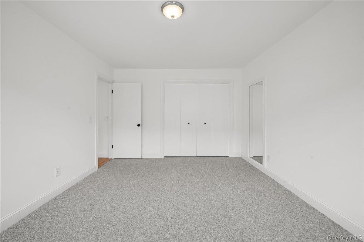 70 Waters Edge, Unit 70 Rye, NY 10580 - Photo 33 of 44 Unfurnished bedroom with carpet and a closet