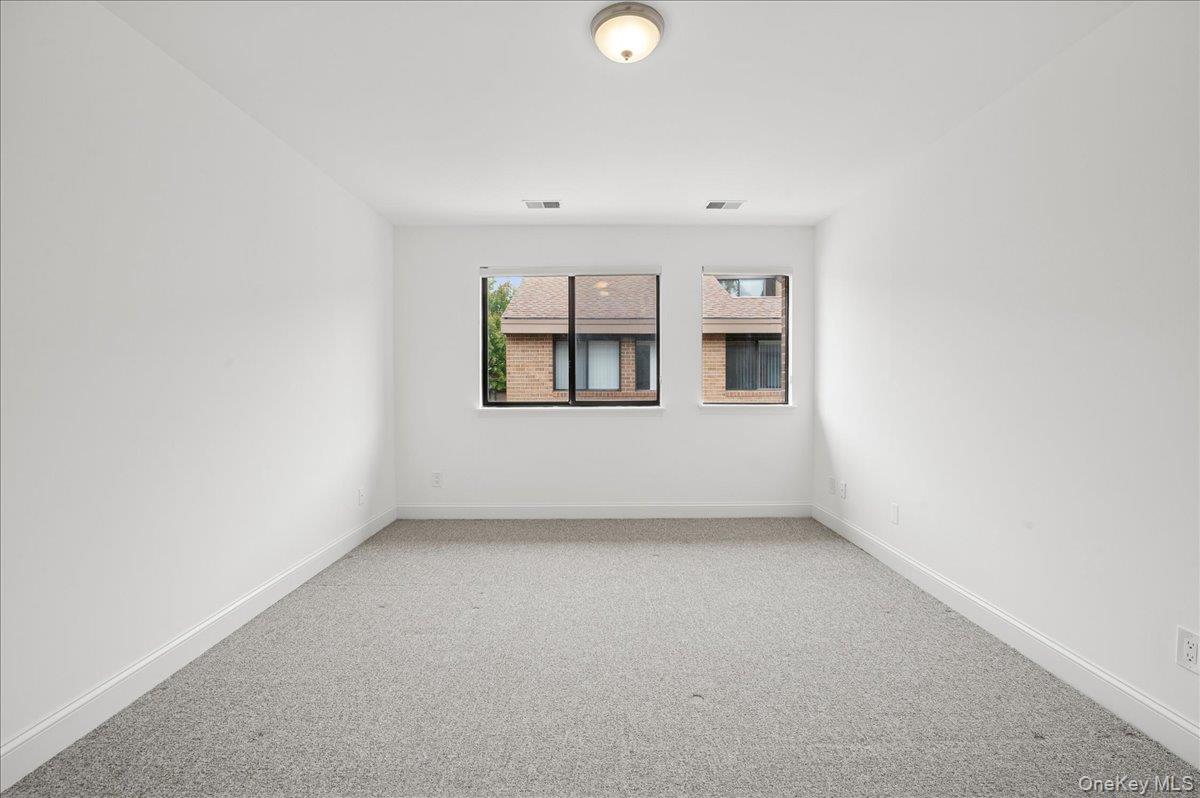 70 Waters Edge, Unit 70 Rye, NY 10580 - Photo 34 of 44 Another bedrooom view, featuring baseboards and light colored carpet