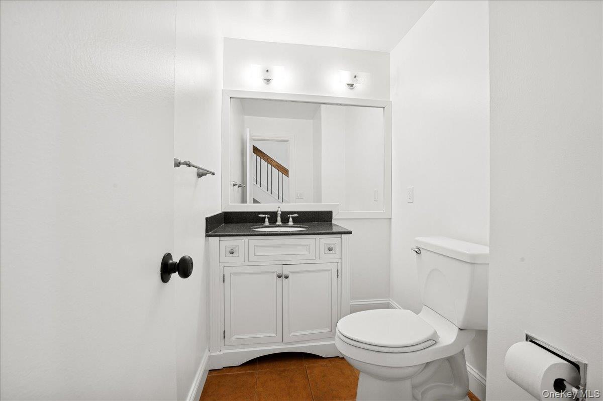 70 Waters Edge, Unit 70 Rye, NY 10580 - Photo 35 of 44 Half bath featuring dark tile patterned flooring and vanity
