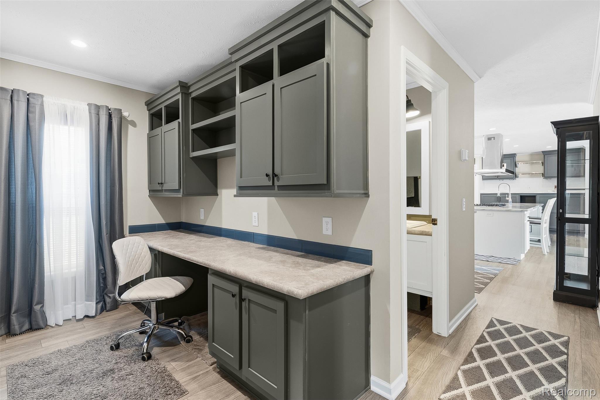 6450 Prince Boulevard Fenton, MI 48430 - Photo 20 of 31 Dedicated workspace featuring built-in cabinetry, an integrated desk surface, and overhead shelving