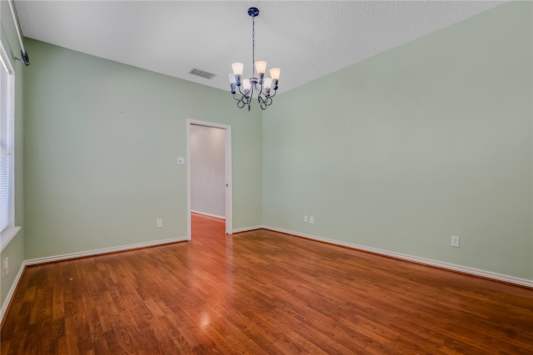 5917 Harvest Hill Road Corpus Christi, TX 78414 - Photo 13 of 40 a view of an empty room with chandelier and wooden floor