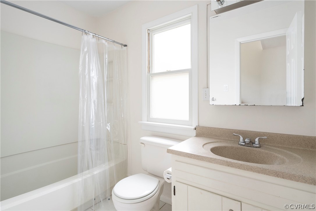 10316 Reams Road Richmond, VA 23236 - Photo 13 of 32 a bathroom with a sink toilet a mirror and shower