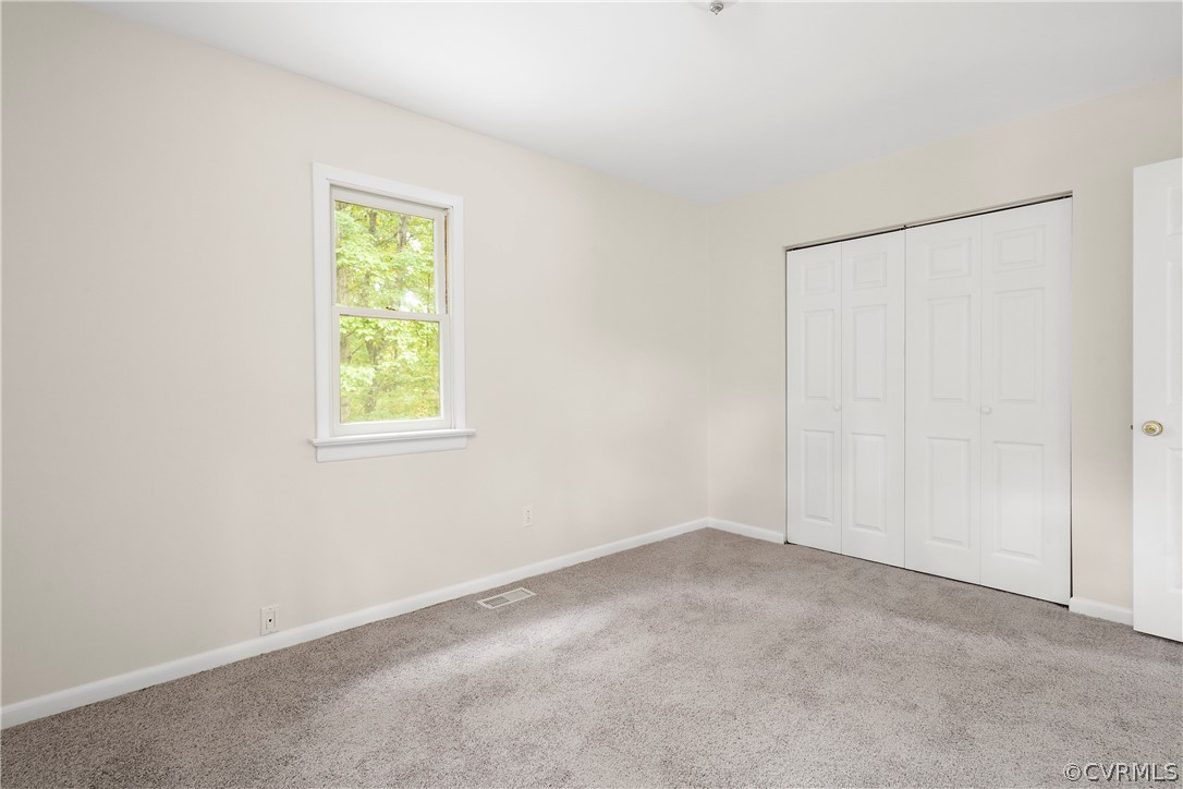 10316 Reams Road Richmond, VA 23236 - Photo 16 of 32 an empty room with a window