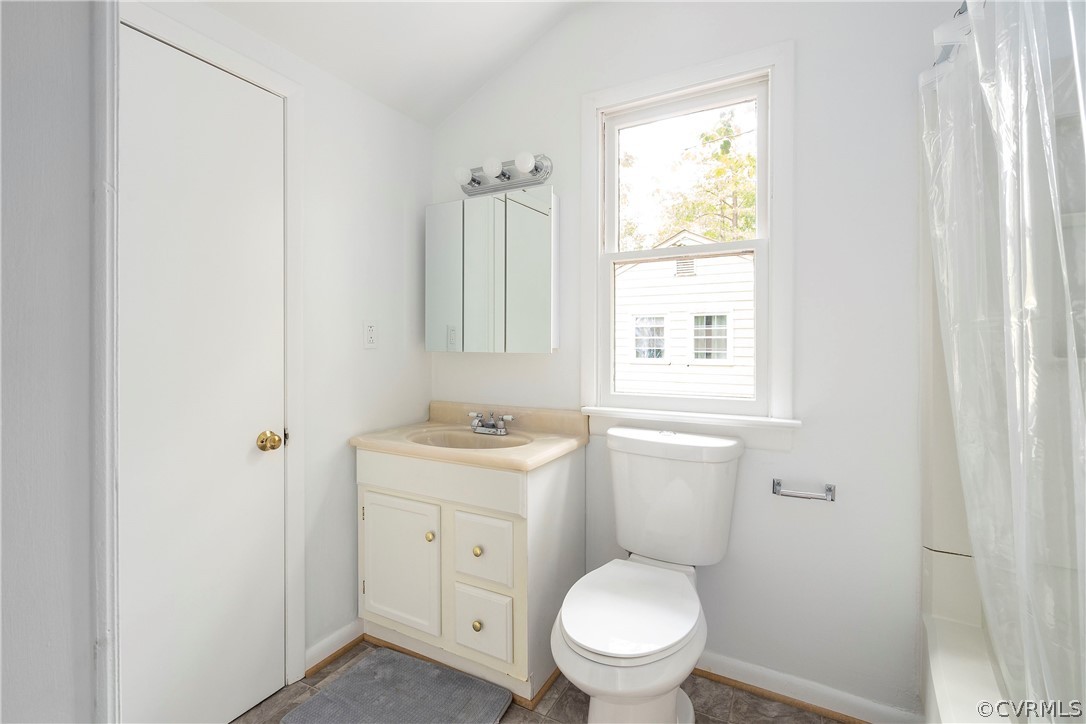 10316 Reams Road Richmond, VA 23236 - Photo 17 of 32 a bathroom with a toilet a sink a shower and a window