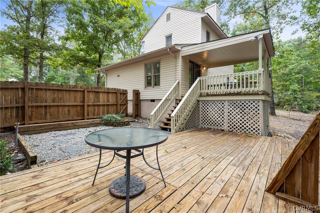 10316 Reams Road Richmond, VA 23236 - Photo 27 of 32 a backyard of a house with wooden floor table and chairs