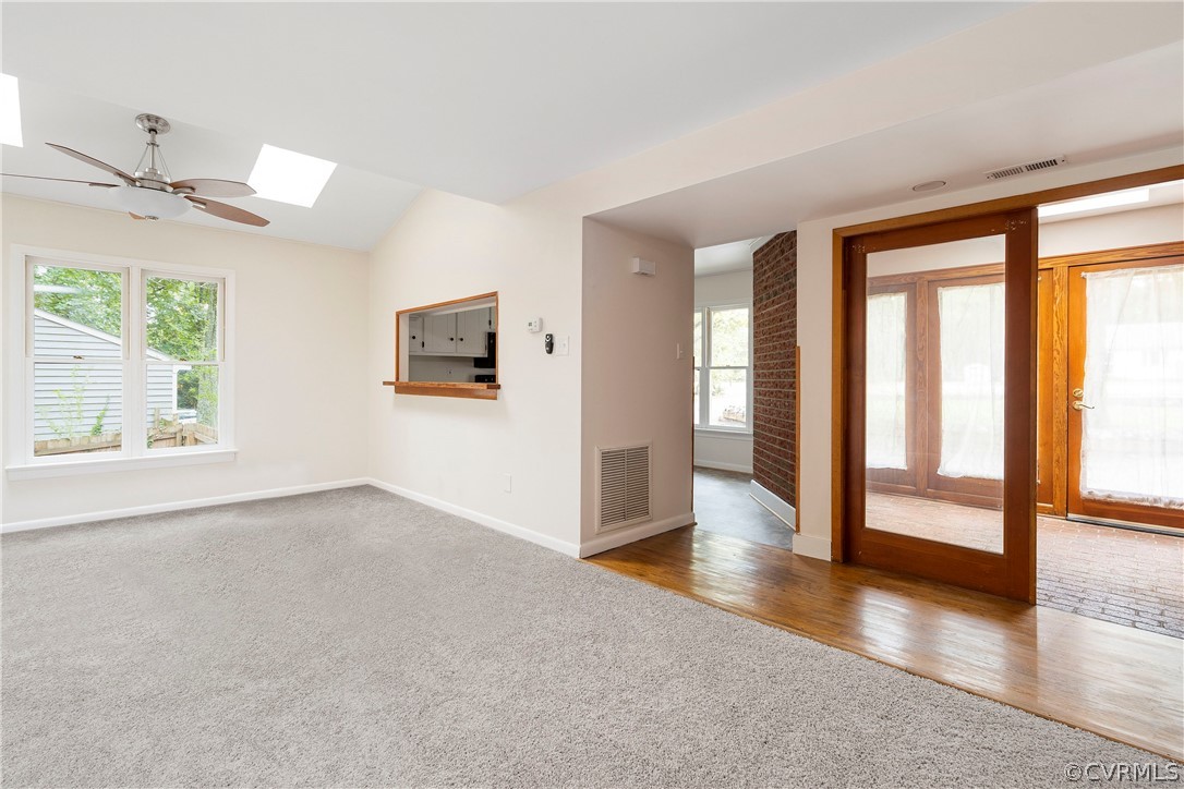 10316 Reams Road Richmond, VA 23236 - Photo 7 of 32 an empty room with wooden floor and windows