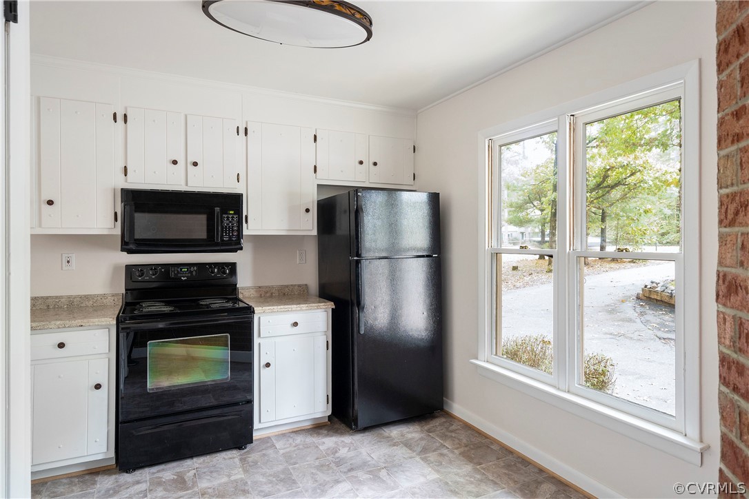10316 Reams Road Richmond, VA 23236 - Photo 9 of 32 a kitchen with a refrigerator and a stove