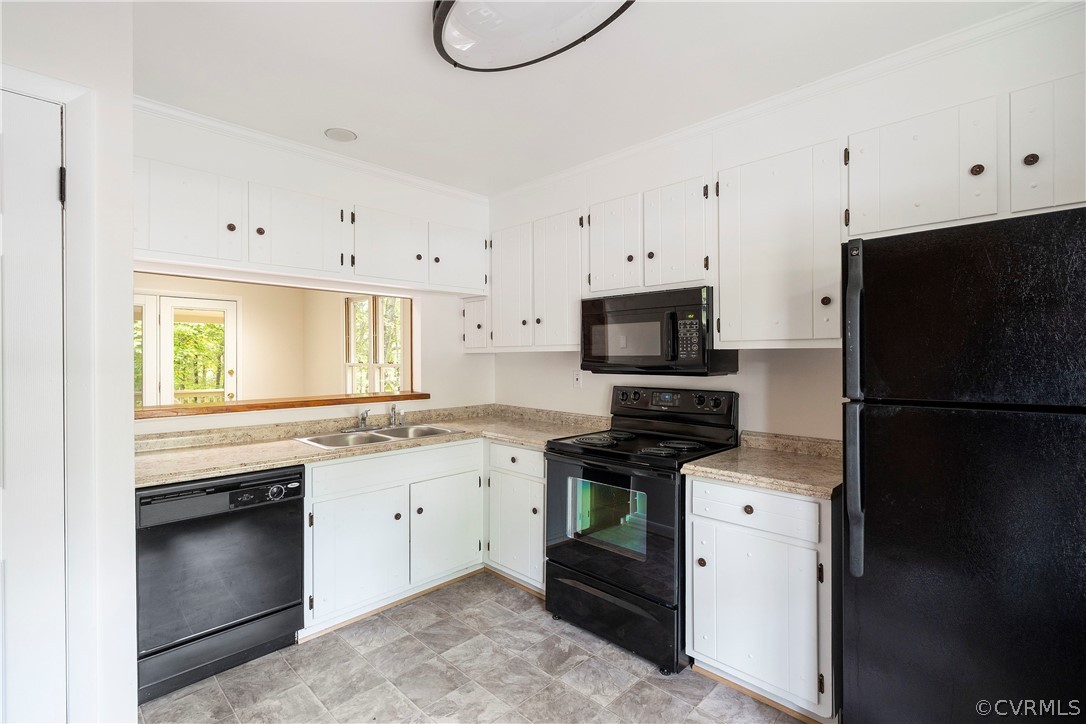 10316 Reams Road Richmond, VA 23236 - Photo 10 of 32 a kitchen with granite countertop a refrigerator stove and microwave