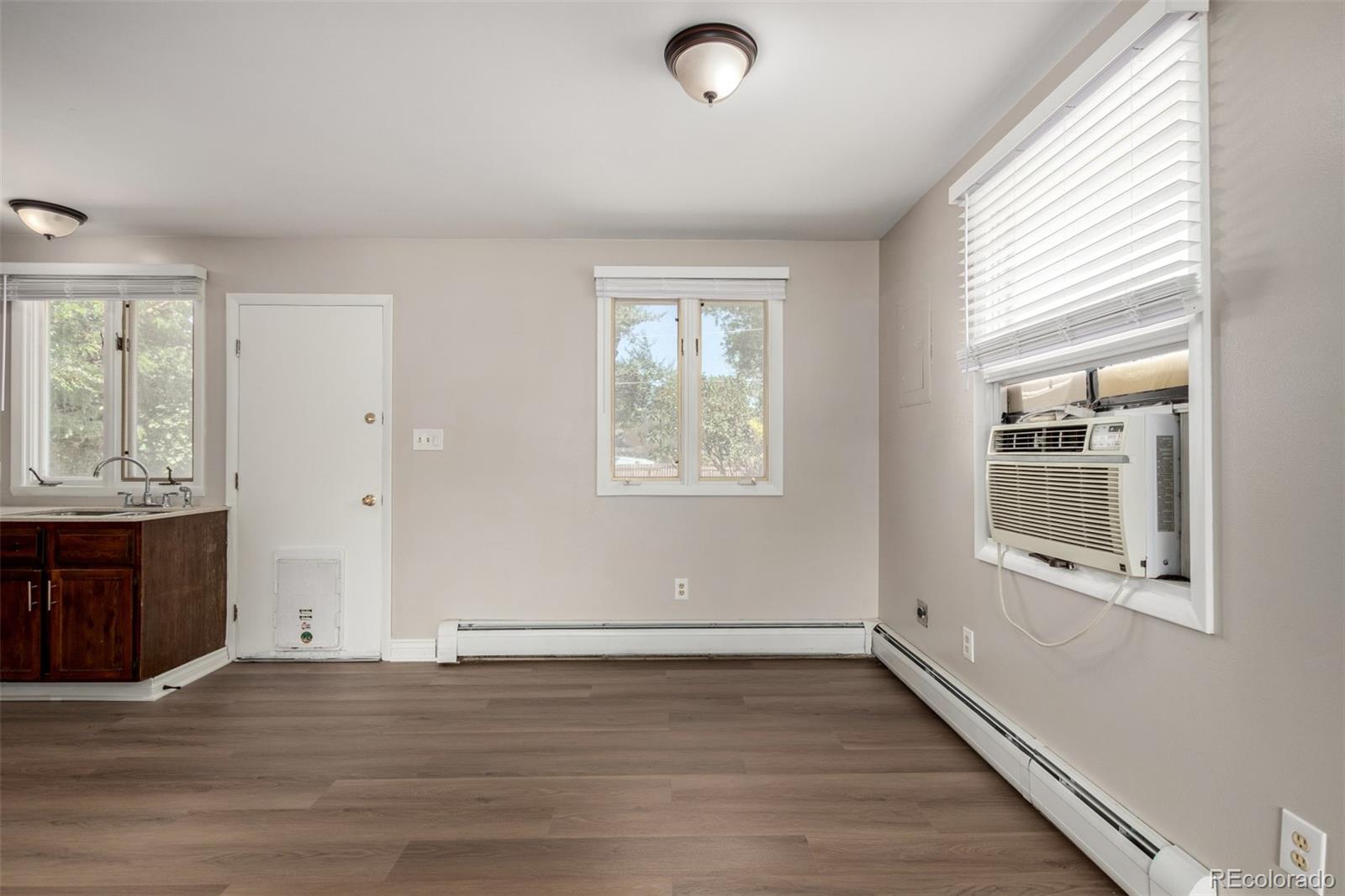 117 6th Street Frederick, CO 80530 - Photo 12 of 43 an empty room with wooden floor and windows