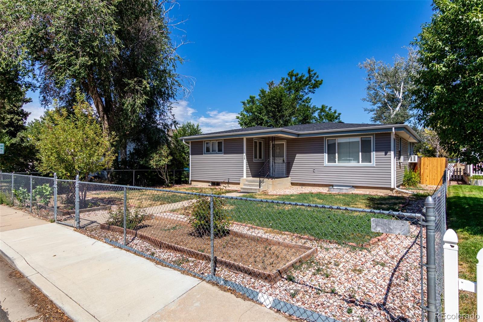 117 6th Street Frederick, CO 80530 - Photo 2 of 43 a view of a house with backyard and sitting area